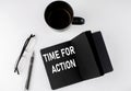 TIME FOR ACTION written text in small black notebook with coffee , pen and glasess on white background. Black-white style Royalty Free Stock Photo