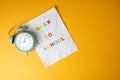 Time for back-to-school concept with clock and notebook paper Royalty Free Stock Photo