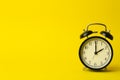 Time background concept. Vintage classic alarm clock on yellow empty background. Time management concept Royalty Free Stock Photo