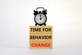 Time for behavior change symbol. Words Time for behavior change on wooden blocks. Black alarm clock. Beautiful white background.