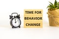 Time for behavior change symbol. Words Time for behavior change on wooden blocks. Black alarm clock, house plant. Beautiful white