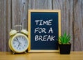 TIME FOR A BREAK text in white chalk handwriting Royalty Free Stock Photo