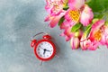 Time celebrate concept. Flower bouquet and clock, flat lay.