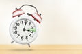 Time change in Austria, spring forward. Summer time concept, over white background. A white alarm clock with a minute Royalty Free Stock Photo