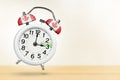 Time change in Canada, spring forward. Summer time concept, over white background. A white alarm clock with a minute Royalty Free Stock Photo