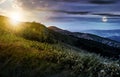 Time change concept over grassy meadow on a hillside Royalty Free Stock Photo