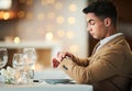 Time check, watch and late date of a man at a restaurant table on valentines day alone. Bokeh lights, night and suit of