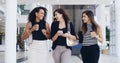 Time for a coffee break. three young beautiful businesswomen walking through a modern office. Royalty Free Stock Photo
