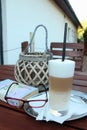 Time for coffee - caffe latte at a restaurant while relaxing with a book Royalty Free Stock Photo
