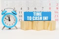Against the background of the calendar is an alarm clock, cubes and a blue block with the inscription - Time to Cash in Royalty Free Stock Photo
