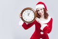 Time Concept and Ideas. Gleeful Red-Haired Santa Helper With Big Round Clock and Showing Time Royalty Free Stock Photo