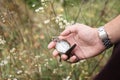 Time concept. New year midnight. Close-up of old gold-plated pocket watch in male hand on natural background. New