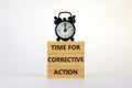 Time for corrective action symbol. Wooden blocks with words `Time for corrective action` on a beautiful white background. Black