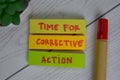 Time For Corrective Action write on sticky notes isolated on Wooden Table