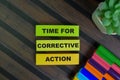 Time For Corrective Action write on sticky notes isolated on Wooden Table