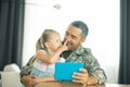 Member of the armed forces coming home and spending time with daughter