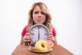 Time for diet slimming. Beautiful woman with clock Royalty Free Stock Photo