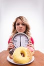 Time for diet slimming. Beautiful woman with clock Royalty Free Stock Photo