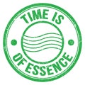 TIME IS OF ESSENCE text on green round postal stamp sign