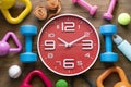 Time for exercising clock, dumbbell, and sport equipment Royalty Free Stock Photo