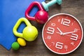 Time for exercising clock and dumbbell and sport equipment Royalty Free Stock Photo