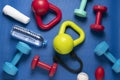 Time for exercising sport equipment, dumbbell, kettlebell with blue yoga mat background, healtyh and workout concept Royalty Free Stock Photo