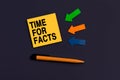 TIME FOR FACTS - concept of text on sticky note. Orange square sticky note, pen and colorful arrows on dark blue background, top