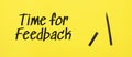 time for feedback sign with black marker on a yellow background. With copy space ready for your text Royalty Free Stock Photo