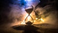 Time flow concept with hourglass with lights and mysterious smoke atmosphere