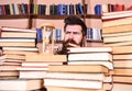 Time flow concept. Man, scientist looks at hourglass. Teacher or student with beard studying in library. Man on serious Royalty Free Stock Photo