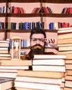 Time flow concept. Teacher or student with beard studying in library. Man, scientist in glasses looks at hourglass. Man Royalty Free Stock Photo