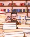 Time flow concept. Teacher or student with beard studying in library. Man, scientist in glasses looks at hourglass. Man Royalty Free Stock Photo