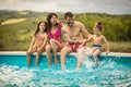 Happy family sitting by the swimming pool Royalty Free Stock Photo