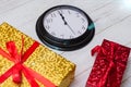 Time for gifts. Colorful gifts and a clock showing twelve