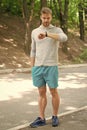 It is time. Good looking sportsman in sportswear outdoors. Active sportsman training. Sportsman living healthy lifestyle