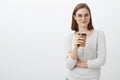 Time grab coffee to work productive. Satisfied relaxed, joyful good-looking woman in glasses and blouse holding paper