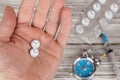 Time heals concept. Male hand holding pills stylized as clock