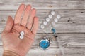 Time heals concept. Male hand holding pills stylized as clock. Alarm and medicine