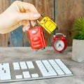 Time for a holiday travel concept. Girl hand with miniature bags on a workplace background