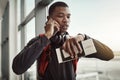 Time is important if you wanna travel the world. a handsome young man checking the time while making a call in an Royalty Free Stock Photo