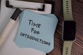 Time for Introductions write on sticky notes isolated on Wooden Table