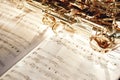 Time for jazz. Close up image of a shiny keys of golden saxophone lying on the sheet of music