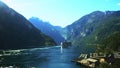 Time lapse clip of a large cruise ship and ferry boat leaving and other boats coming to Geiranger, Norway on the fjord.