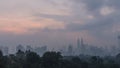 Time-lapse of cloudy Kuala Lumpur city centre skyline during sunrise