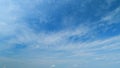 Flying moving white clouds in a blue sky. Blue sky background with many layers tiny stratus cirrus clouds. Time lapse. Royalty Free Stock Photo