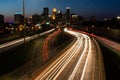 Time-lapse of highway lights in Minneapolis Minnesota at night with a cityscape in the background Royalty Free Stock Photo