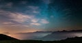 Time Lapse of the Milky way and the starry sky moving over the Italian Alps with fog and moisture resulting in a dreamlike effect.