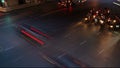 Time lapse of traffic long exposure light trails across road junction during rush hour, from evening to dusk, unrecognizable faces