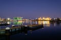 Valencia harbor, port night lights reflection in water, buildings Royalty Free Stock Photo