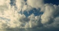 Timelapse of white cumulus obscuring the sky. Evening tones, warm white and dark blue. 4K footage.